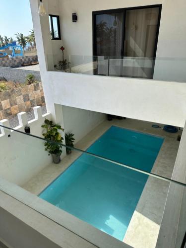 a swimming pool in the middle of a house at Hotel Casa Prisca in Coyuca