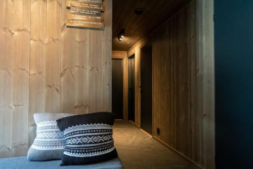 a room with a bed with a pillow on it at New, modern, cosy hut close to Norefjell Ski & Spa in Surteberg