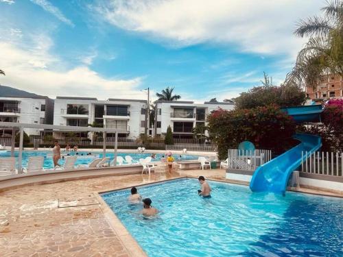 a group of people in a swimming pool at Apartasol Santa Fe de Antioquia in Santa Fe de Antioquia