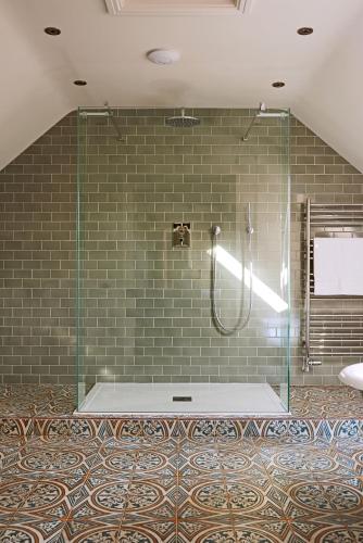 a shower with a glass door in a bathroom at The Millhouse, South Courtyard in Ledbury