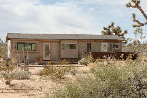 a small house in the middle of the desert at Joshua Tree Modern Cabin- Goat Mountain Rising in Landers