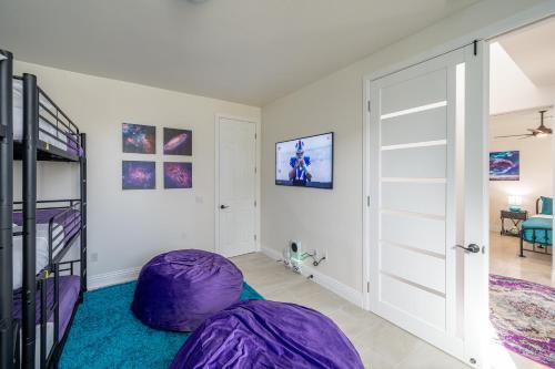 a room with a purple bean bag chair and a bedroom at Coachella Play - 6BR Multi-Gen Fun Zone and Retreat with free heated pool in Indio