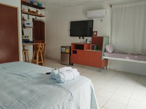 a bedroom with a bed with folded towels on it at Villa Akbal with private pool in Bacalar