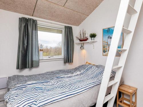a bedroom with a bunk bed and a window at Holiday home Vinderup XXVI in Vinderup