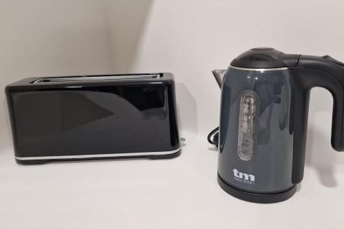 a black toaster sitting next to a toaster oven at casa y piscina en un parque natural in Benicàssim