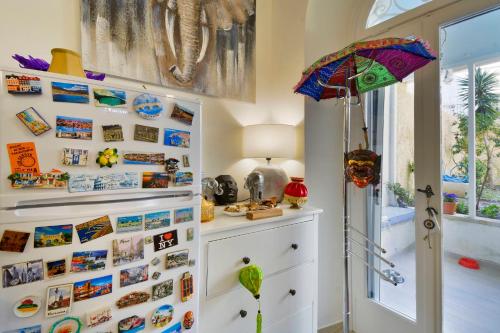 a room with a wall covered in pictures and an umbrella at Τhe Hidden Garden in Corfu Town