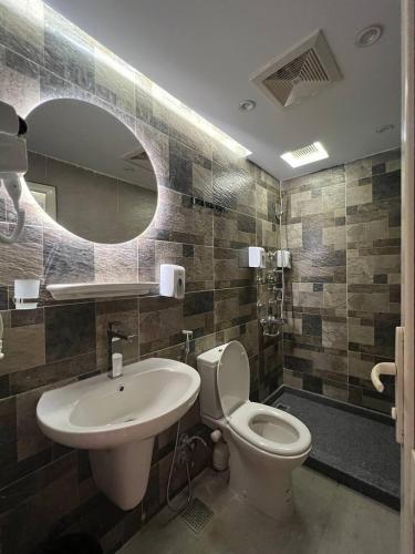 a bathroom with a sink and a toilet and a mirror at Space Hostel in Cairo