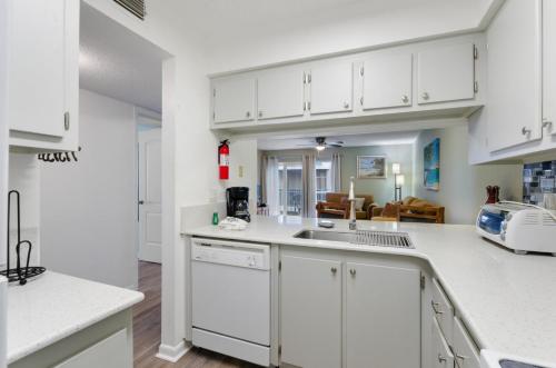 a kitchen with white cabinets and a sink at #250G Madeira Beach Yacht Club in St Pete Beach