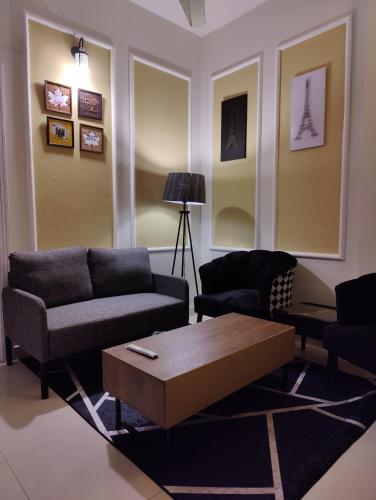 a living room with couches and a coffee table at 2 Bedrooms Presidential Apartment-HS Apartment in Islamabad