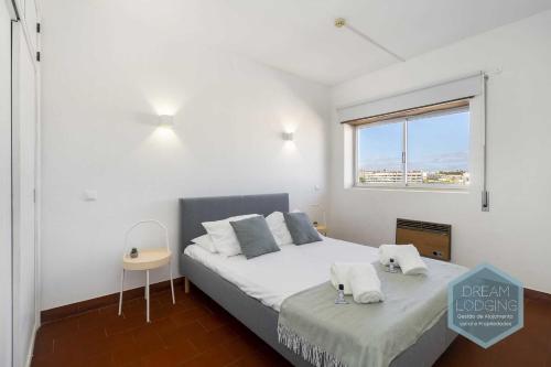 a bedroom with a bed with two towels on it at Casa Azul 714 Dream Lodging in Albufeira