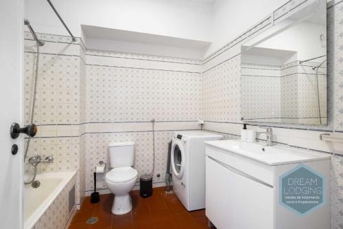 a bathroom with a toilet and a sink and a tub at Casa Azul 714 Dream Lodging in Albufeira