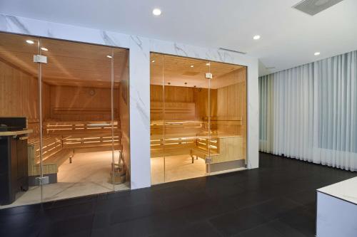 a large room with glass doors and a room with tables at Radisson Blu Hotel Zurich Airport in Kloten