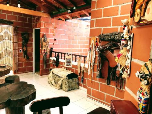 a room with a brick wall with a guitar on the wall at Villa Luz in San Jerónimo