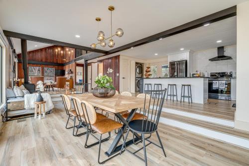 a kitchen and living room with a wooden table and chairs at Lago Vista Home with Putting Green, Pool and Jacuzzi in Leander