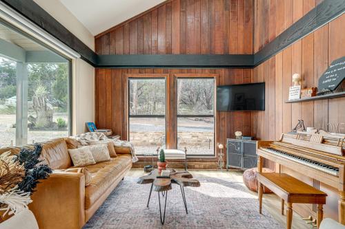 a living room with a couch and a piano at Lago Vista Home with Putting Green, Pool and Jacuzzi in Leander