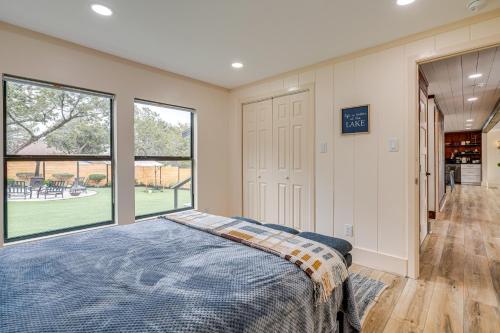 a bedroom with a bed and a large window at Lago Vista Home with Putting Green, Pool and Jacuzzi in Leander