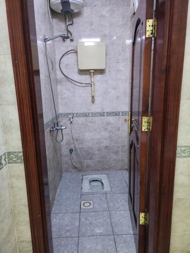 a bathroom with a shower with a toilet in it at شقة طيبه المدينة 5 in Al Madinah