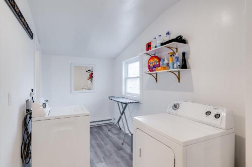 a white laundry room with a washer and dryer at Charming Retreat Near XU in Cincinnati