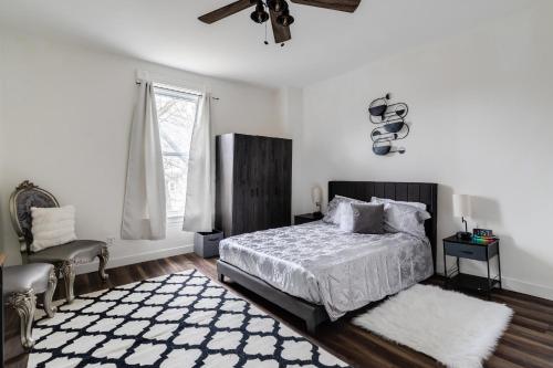 a bedroom with a bed and a chair and a window at Charming Retreat Near XU in Cincinnati