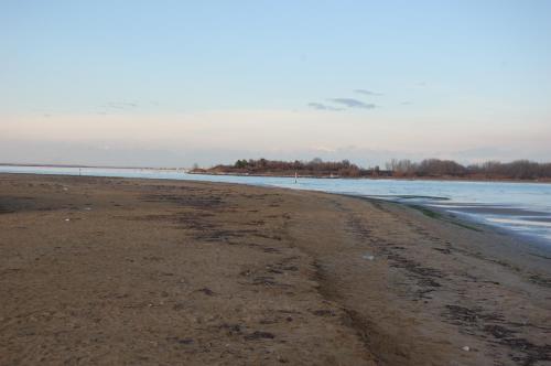 an empty beach with the ocean in the background at Hotel Irene in Lignano Sabbiadoro