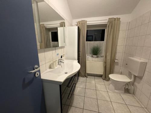 a bathroom with a sink and a toilet at Alte Schmiede Hotel & Restaurant in Jork
