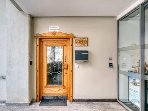 a wooden door in a building with a sign above it at Bergliebe in Kappl