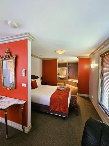 a hotel room with a bed and a bathroom at The Camperdown Mill in Camperdown
