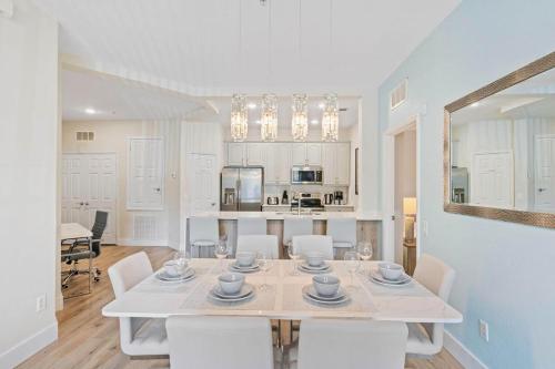 a white dining room with a white table and chairs at The Epic London Vista Cay Orlando Next to the club in Orlando