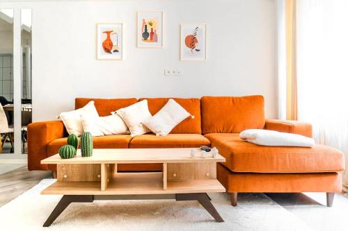 an orange couch in a living room with a coffee table at The most popular Centre Of Kadikoy in Istanbul