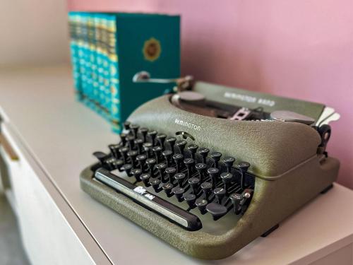 an old typewriter sitting on a counter next to a box at Apartment 5 - Uk42736 in Whitstable