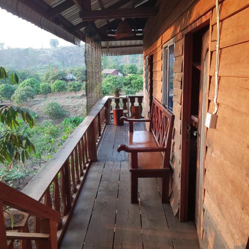 a porch of a house with a bench on it at Banlung Mountain View Treks & Tours in Banlung