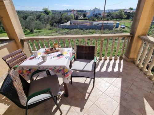 einen Tisch und Stühle auf einem Balkon mit Aussicht in der Unterkunft Apartments with a parking space Sveti Filip i Jakov, Biograd - 16708 in Sveti Filip i Jakov