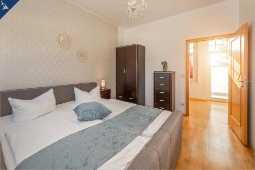 Un dormitorio con una cama grande con una almohada azul. en Villa Linde FeWo 4, en Ahlbeck