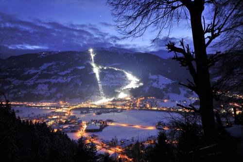 a view of a city and a river at night at Ferienwohnung Bergheim in Fügenberg