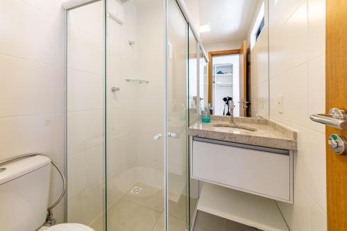 a bathroom with a shower and a toilet and a sink at Apto Póximo a Praia de Barra de São Miguel - Destino BSM 106 A in Barra de São Miguel