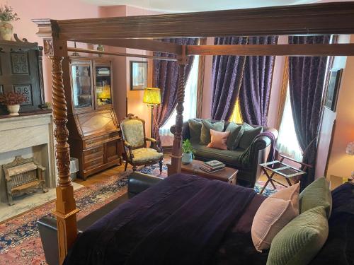 a bedroom with a bed and a living room at Vineyard Mansion B&B in Saint Joseph