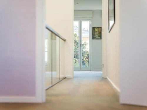 an empty hallway with a door and a mirror at Sophisticated art deco in the heart of Toorak in Melbourne