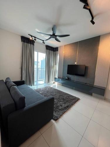 a living room with a couch and a flat screen tv at Mont kiara Warmly Home A-29-06 in Kuala Lumpur
