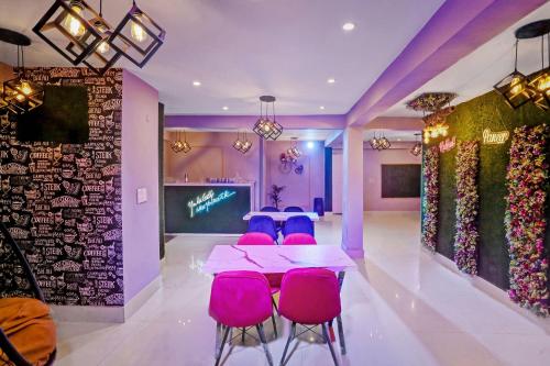 a meeting room with pink chairs and a table at Collection O Hotel Silver Palace in New Delhi