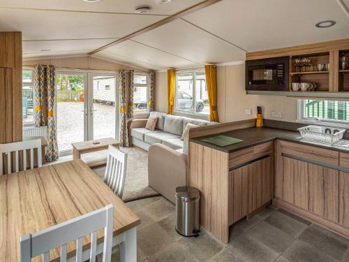 a kitchen and living room of a caravan at The Trout Van - Ukc6621 in Aberlour