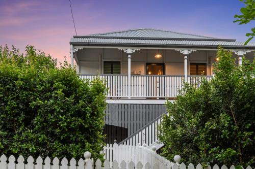 a white fence in front of a house at Spacious and Charming Queenslander in Ipswich in Bundamba