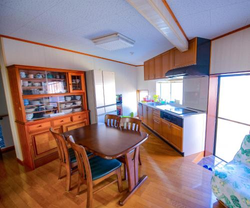 a kitchen with a table and chairs in a room at 忠大　 in Ōbe