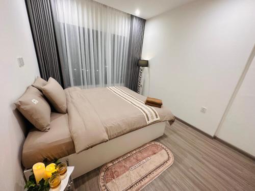 a small bedroom with a bed with a window at Vinhomes Grand Park - FEBRUARYroom in Gò Công