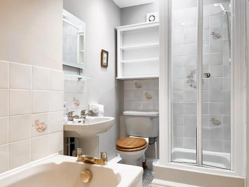 a white bathroom with a toilet and a sink at River View in Youlgreave