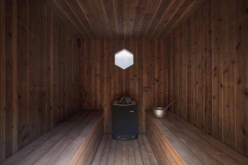 a wooden room with a trash can and a window at 6ishiki in Kameoka