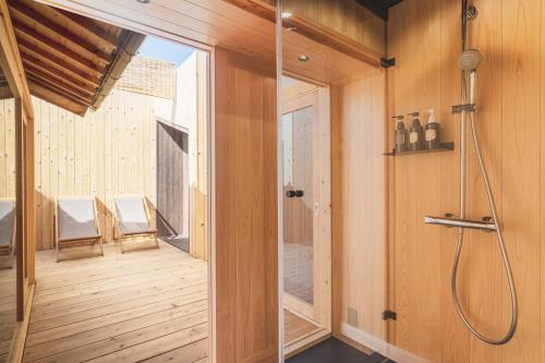 a bathroom with a shower and a glass door at 6ishiki in Kameoka