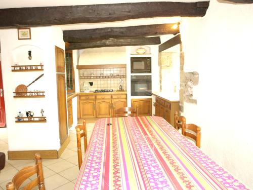 a kitchen with a table with a colorful table cloth on it at Maison de 3 chambres avec jardin amenage a Sibiril a 3 km de la plage in Sibiril