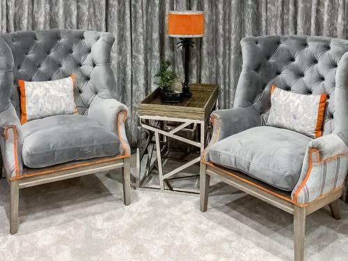 a living room with two chairs and a table at Woodlea Farm in Four Marks