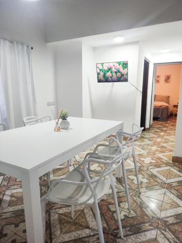 a white table and chairs in a room at Apartamentos Mara - 100m de Termas in Federación