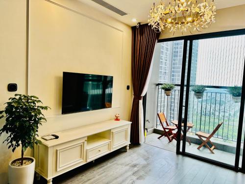 sala de estar con TV y ventana grande en Xjng Homes - Ocean Park, en Hanói